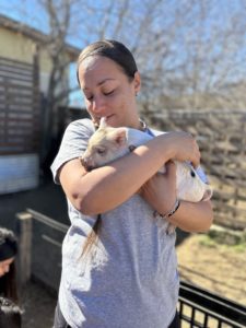 woman holding a piglet